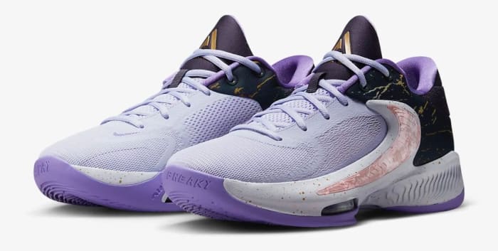 View of purple and black Nike Zoom Freak shoes.